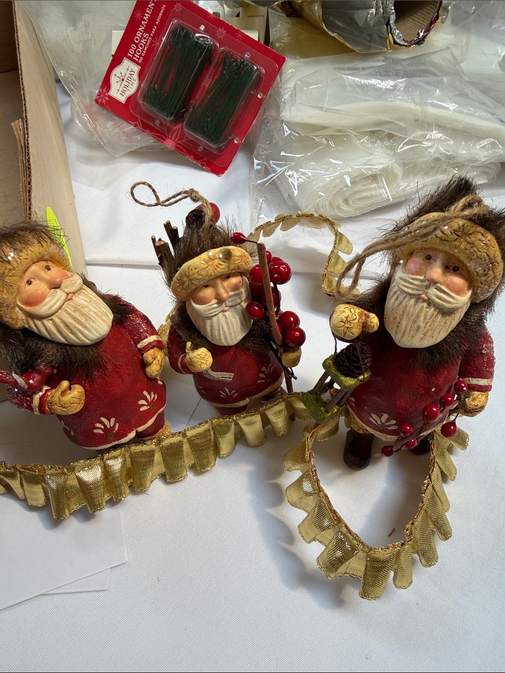 Set of three vintage Santa’s carrying different objects. Ornaments or shelf.